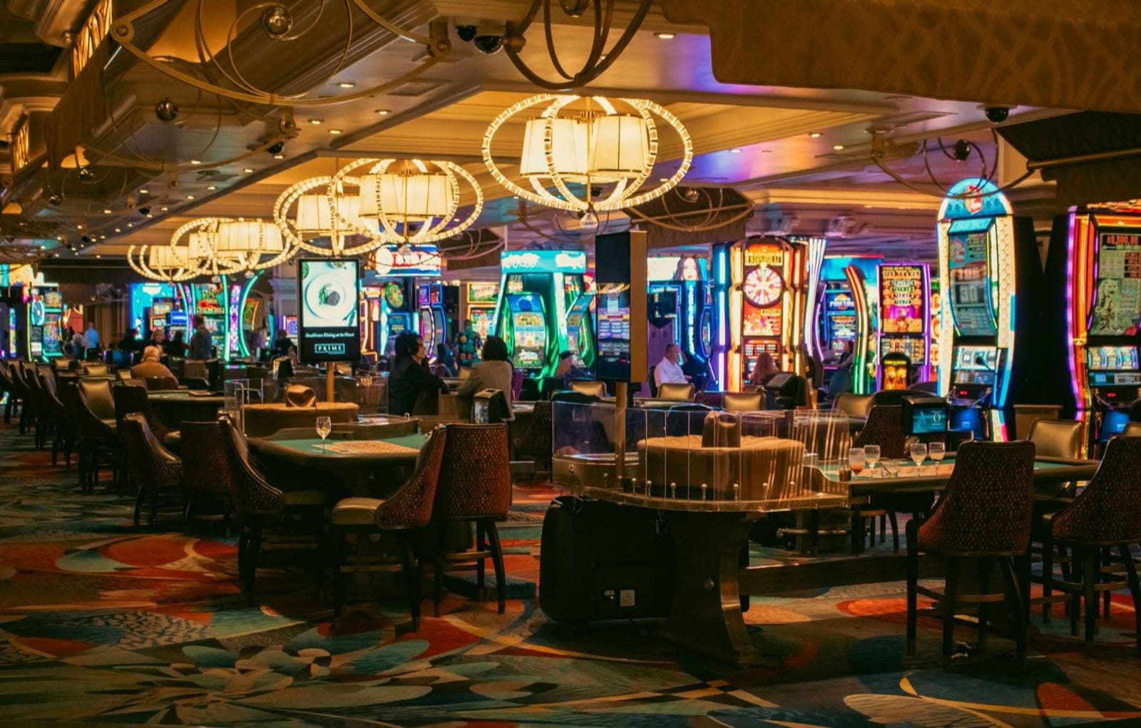 Casino gaming floor with tables and chandeliers