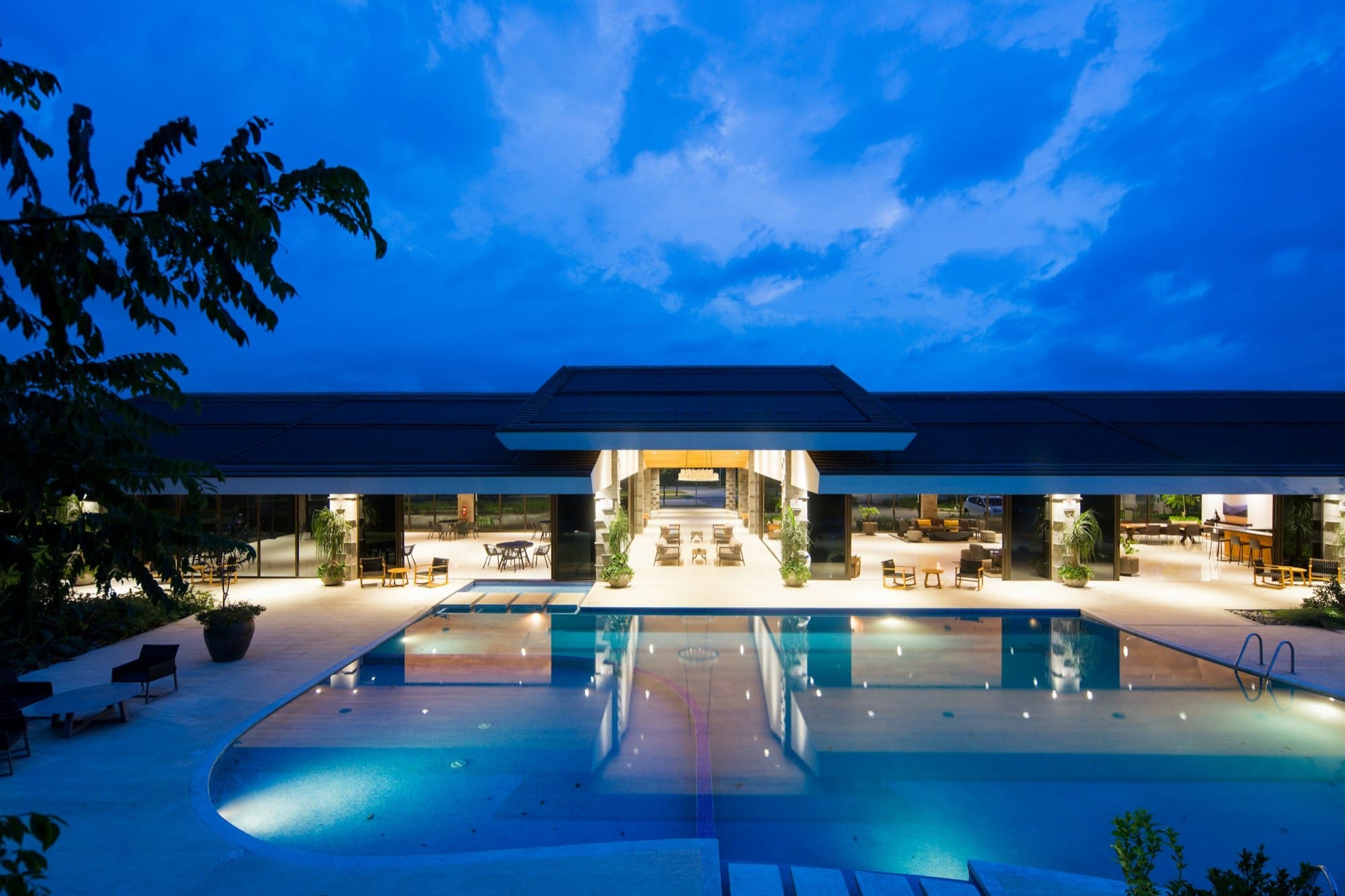 Resort pool and terrace lit at dusk