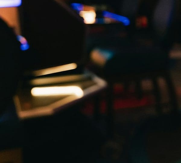Rows of slot machines in a dimly lit casino hall